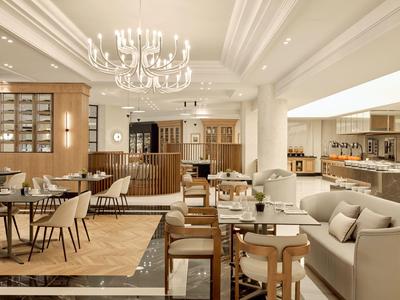 Salle à manger d'hôtel élégante avec mobilier moderne aux tons neutres et lustres.