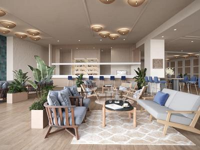 Area lounge moderna in hotel con divani, poltrone e illuminazione elegante.