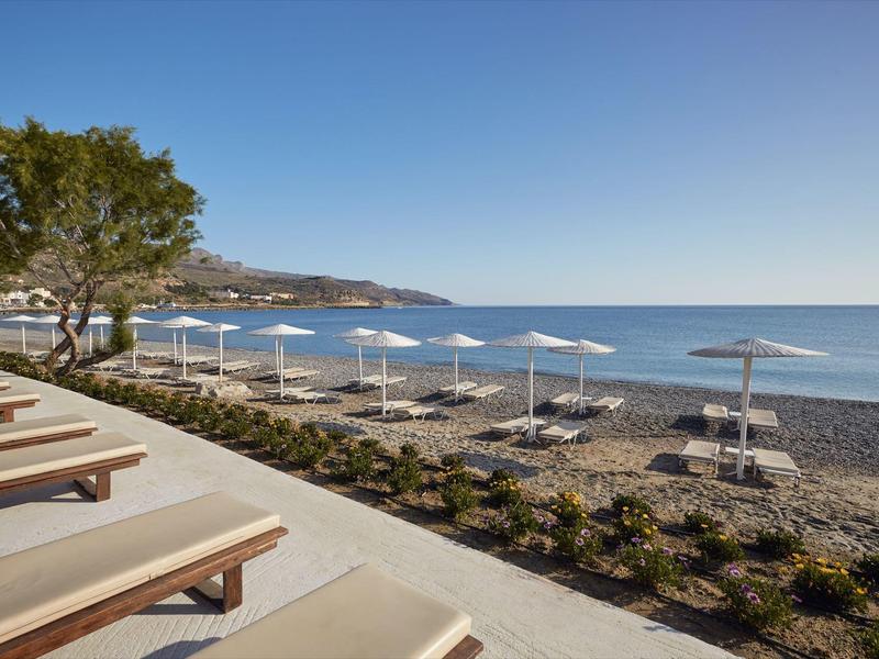 Spiaggia con lettini e ombrelloni vicino al mare sotto un cielo limpido