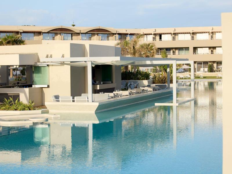 Luxury hotel with modern architecture and a large outdoor pool.