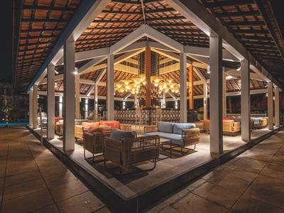 Open, modern rooftop area with warm lighting and cozy seating arrangements.