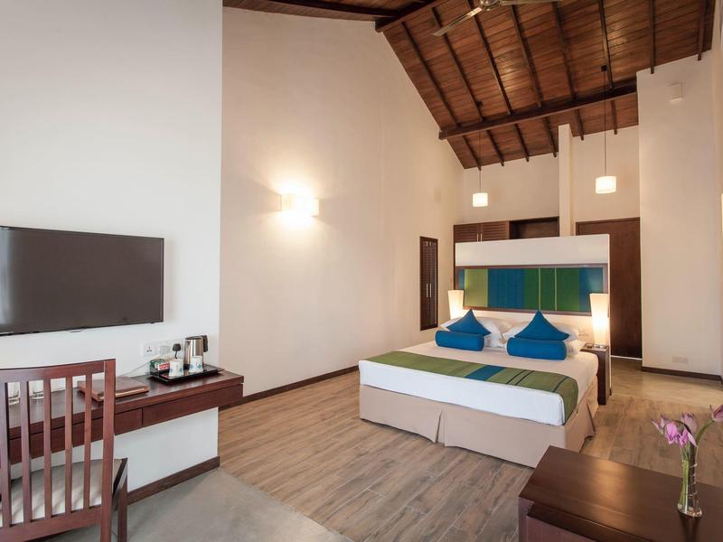 Nowoczesny pokój hotelowy z łóżkiem podwójnym, drewnianymi meblami i drewnianą podłogą.