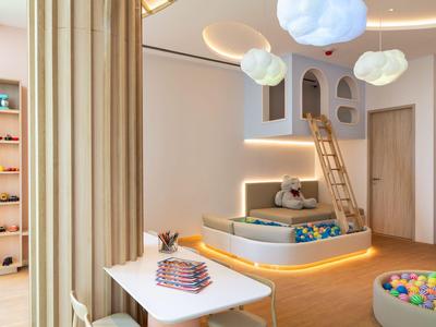 Lichte, moderne hotelkamer met kinderspeelruimte, ballenbak en gezellige speelhoek.