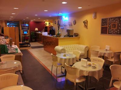 Hotel bar with seating areas, tables, and warm lighting.