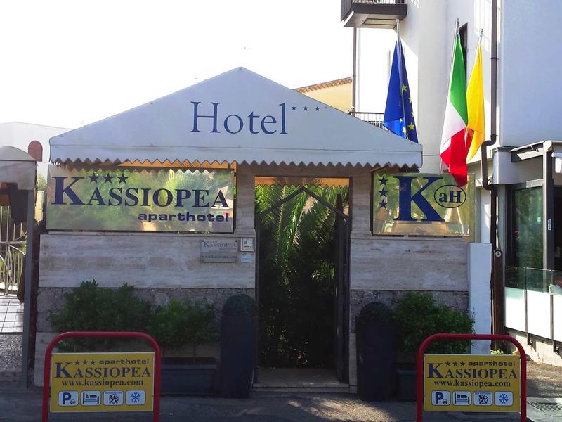 Entrance area of a hotel with a tent and several country flags.