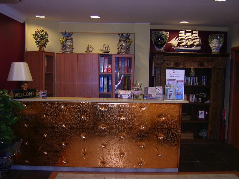 Reception with decorative illuminated counter and books in a warmly lit room.