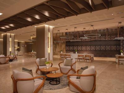 Modern hotel lobby with elegant armchairs and warm lighting design