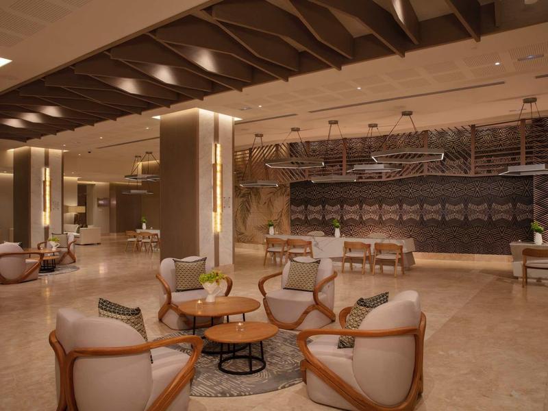 Modern hotel lobby with elegant armchairs and warm lighting design