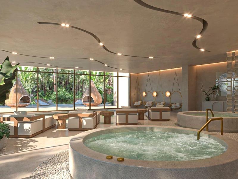 Nowoczesna strefa wellness z okrągłym jacuzzi, dużymi oknami i stylowym wnętrzem.