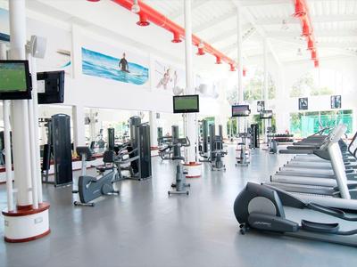 Bright gym with modern equipment and treadmills in a hotel.