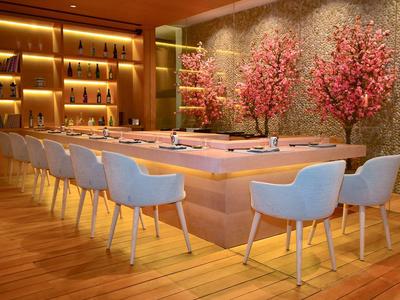 Elegante zona pranzo moderna con sedie blu e scaffali del bar illuminati, decorata con alberi di ciliegio in fiore.