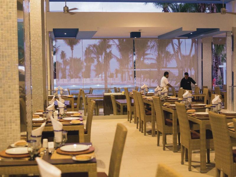 Brightly lit restaurant with neatly set tables and chairs in rows