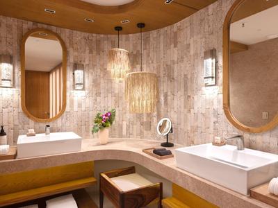 Elegante bagno d'hotel con due grandi specchi, lavandini moderni e illuminazione calda.