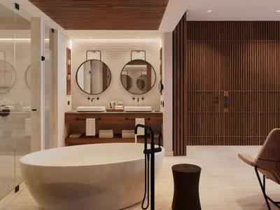 Moderne badkamer met vrijstaand bad en ronde spiegels aan de muur.