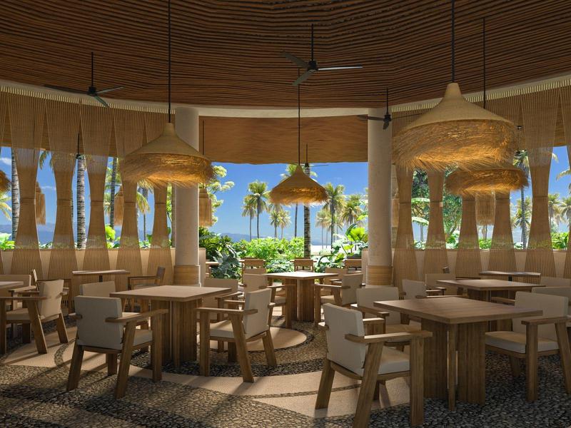 Licht hotelrestaurant met houten meubels en uitzicht op tropische planten en zee.