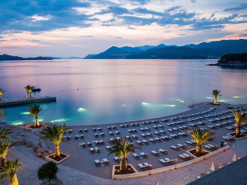 Modern lounge interior with bean bags, sofas, and large screens in vibrant colors.