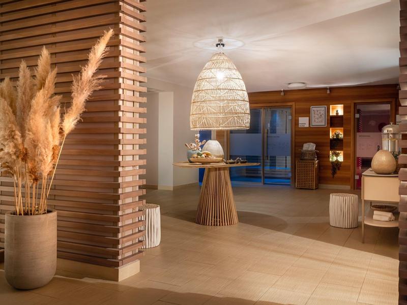 Modernly furnished hotel lounge area with warm lighting and wooden details.