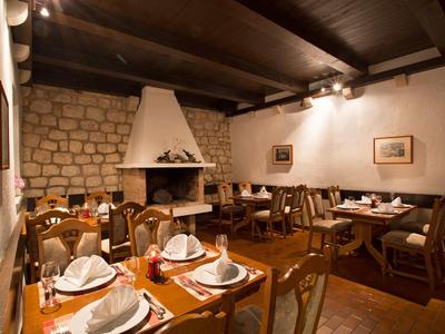Cozy dining room with wooden furniture and fireplace in a hotel.