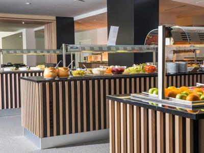 Buffet with fresh fruit and dishes in a modern hotel restaurant.