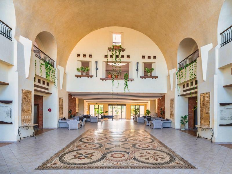 Große helle Empfangshalle mit Verzierungen und Balkon im Hotel.