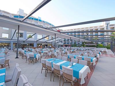 Large hotel terrace with tables and chairs set up for outdoor dining.