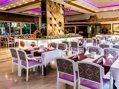 Elegante sala da pranzo con tavoli apparecchiati e accenti viola in un hotel.