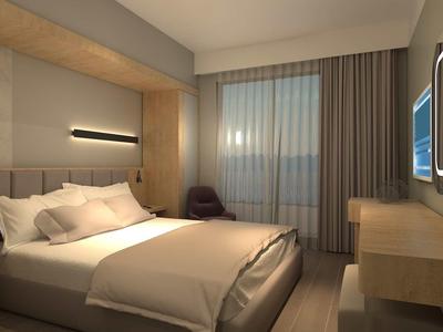 Modernes Schlafzimmer mit großem Bett, Holzmöbeln, klaren Linien und gedämpftem Tageslicht.