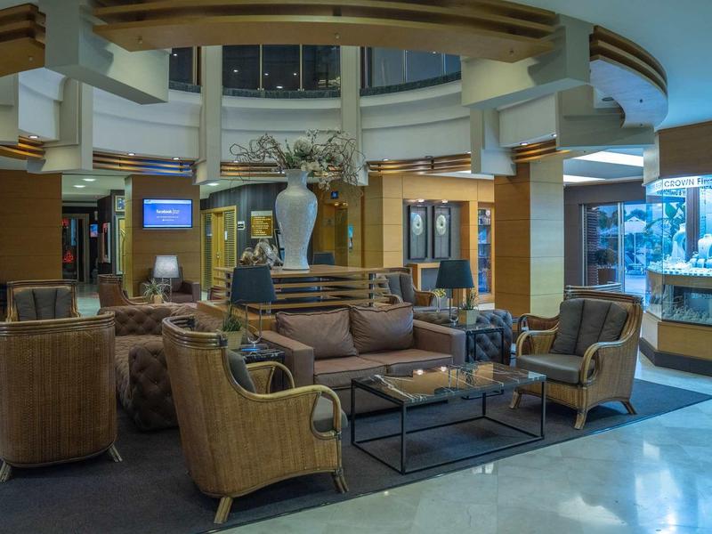 Gezellig hotel lobby met banken, fauteuils en decoratieve elementen.