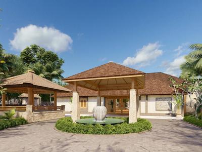 Ein tropisches Resort mit Hauptgebäude, Palmen und klar blauem Himmel.