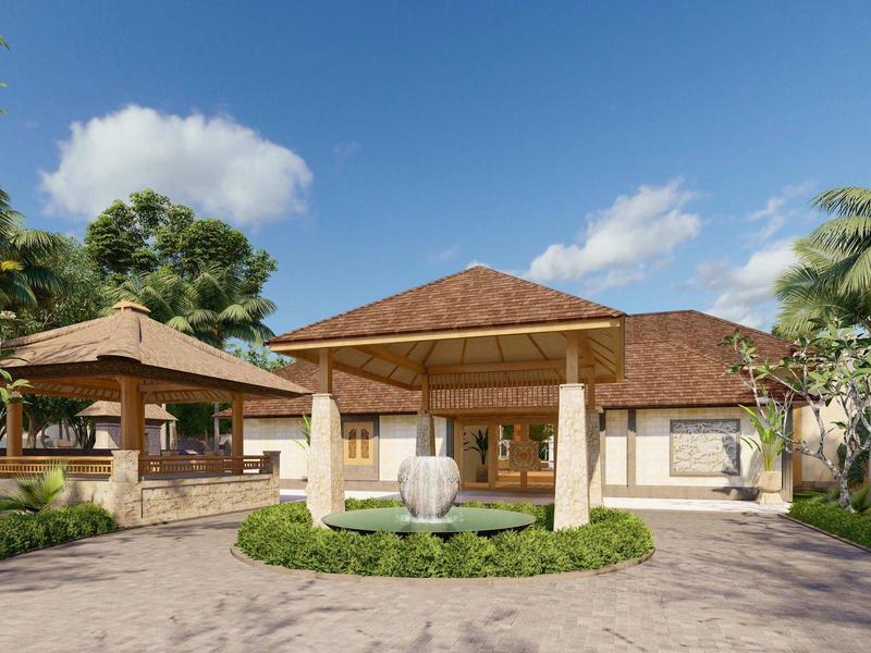 Ein tropisches Resort mit Hauptgebäude, Palmen und klar blauem Himmel.