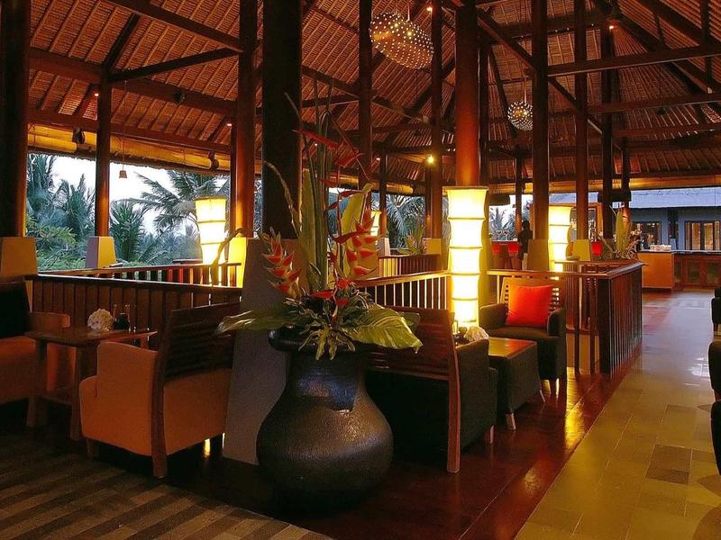 Gemütliches Restaurant mit Holzvertäfelung, roten Wänden, Pflanzen und bequemen Sesseln.