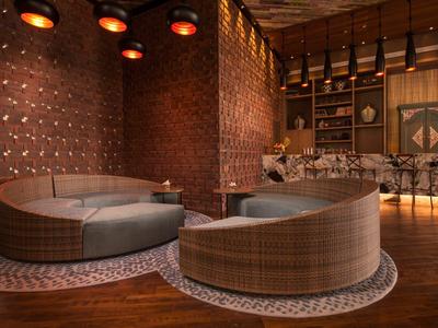 Gemütliche Rundsofas in warm beleuchtetem Hotel-Lounge-Bereich mit Holzboden.