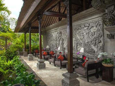 Outdoor seating area with carved stone wall and tropical garden view
