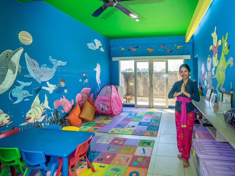 Luxurious pool area with loungers, palm trees, and sunset view.