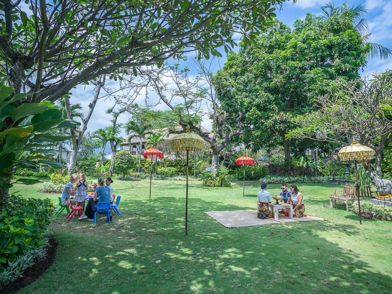 Green garden landscape with seating areas and decorative parasols