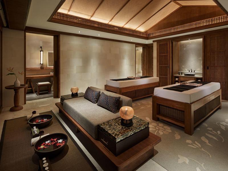 Salle de spa moderne avec tables de massage et ambiance cosy.