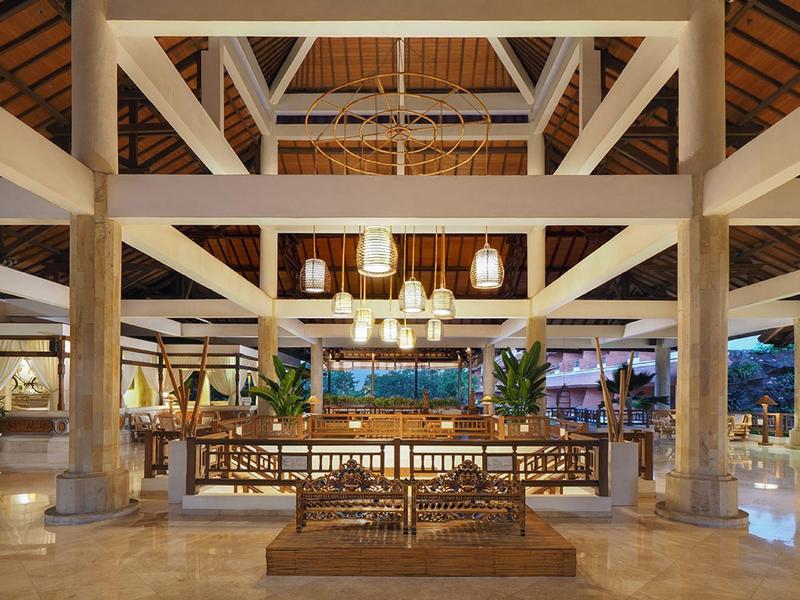 Interno sofisticato di un hotel con mobili in legno sotto un soffitto alto.