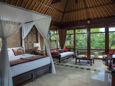 Luxusní pokoj s postelí s baldachýnem, velkými okny a výhledem na tropickou přírodu