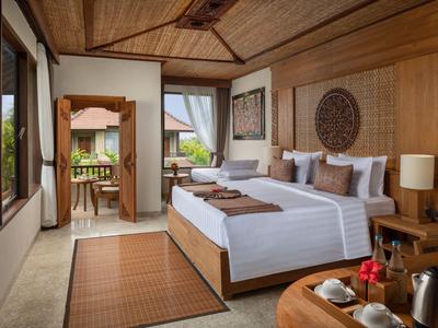 Gezellige hotelkamer met houten meubels, groot bed, tapijt en toegang tot balkon.