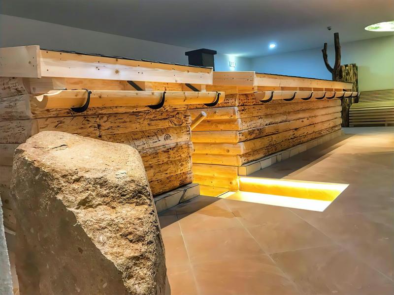 Interior with large rustic wooden bar and warm ambiance