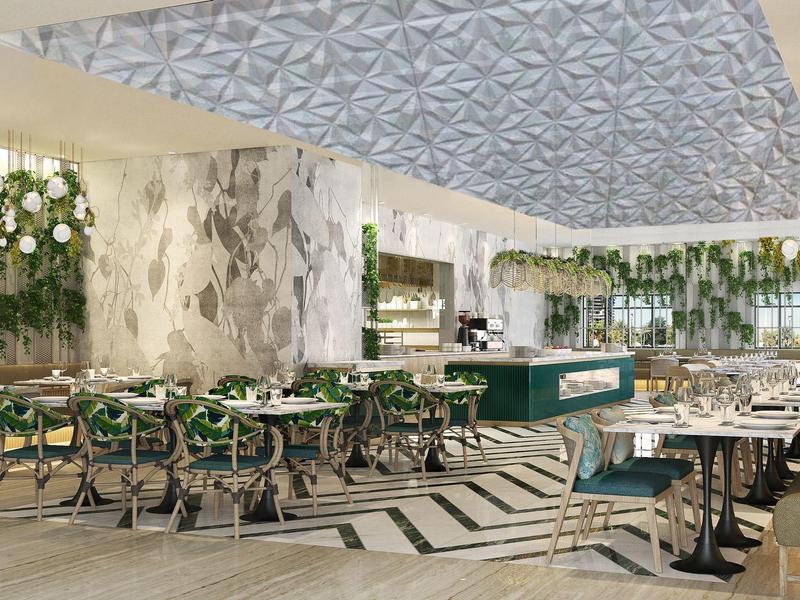 Moderner Gastraum mit grünen Stühlen, großen Blumenarrangements und auffälliger Decke.