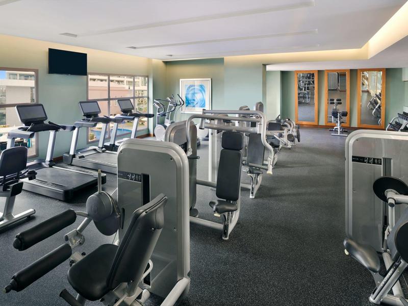 Salle de sport moderne avec divers équipements d'entraînement dans un hôtel