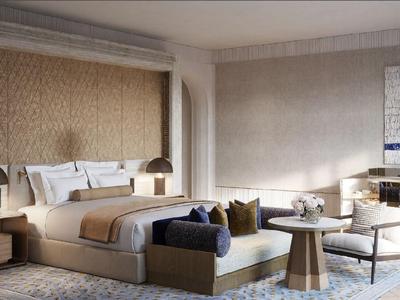 Elegantes Hotelzimmer mit großem Bett, Sesseln und heller, neutraler Farbgebung.