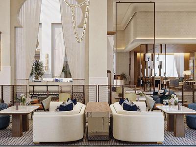 Elegantes Hotellobby-Interieur mit weißen Sofas, blauen Teppichen und modernen Lampen.