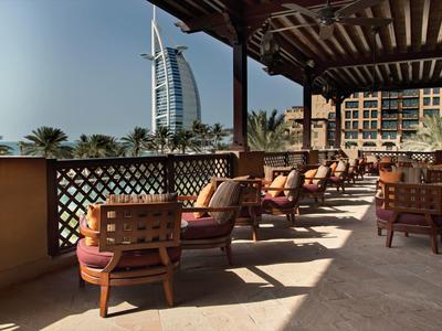 Slunná terasa s pohodlnými křesly a výhledem na hotel Burj Al Arab.