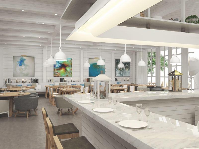 Bright restaurant with modern decor, white walls, and cozy seating areas.