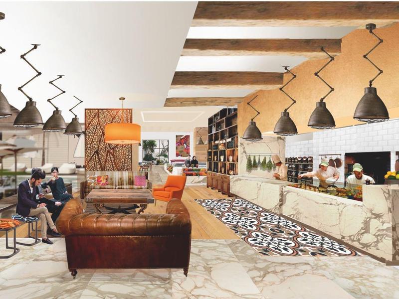 Strand mit blauen Liegestühlen und Sonnenschirmen, dahinter ruhiges Meer und Wolkenkratzer bei klarem Himmel.