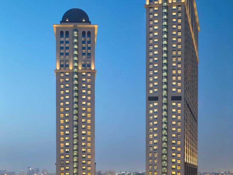 Verlichte twee wolkenkrabbergebouwen bij schemering met heldere lucht