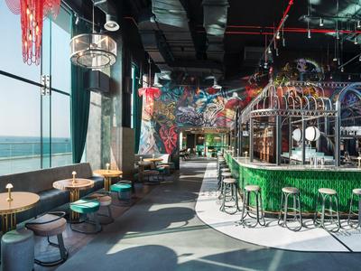 Modern restaurant with panoramic sea view and seating at bar and tables