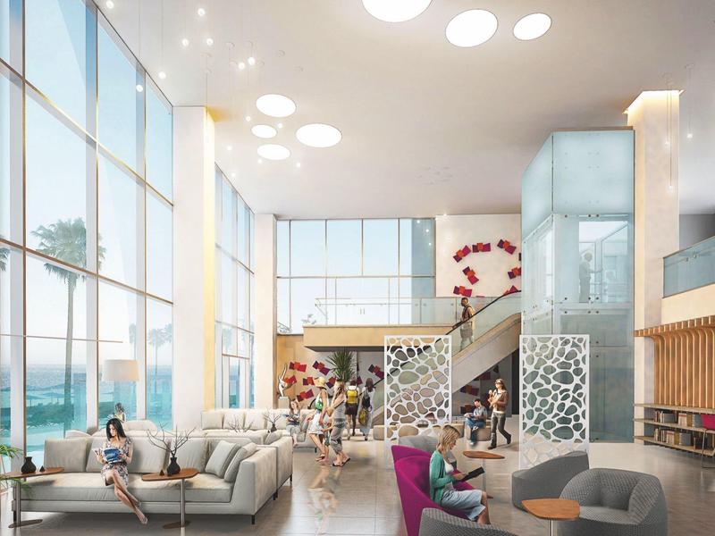 Modern bright hotel lobby with large windows, cozy seating areas, and elegant decor.